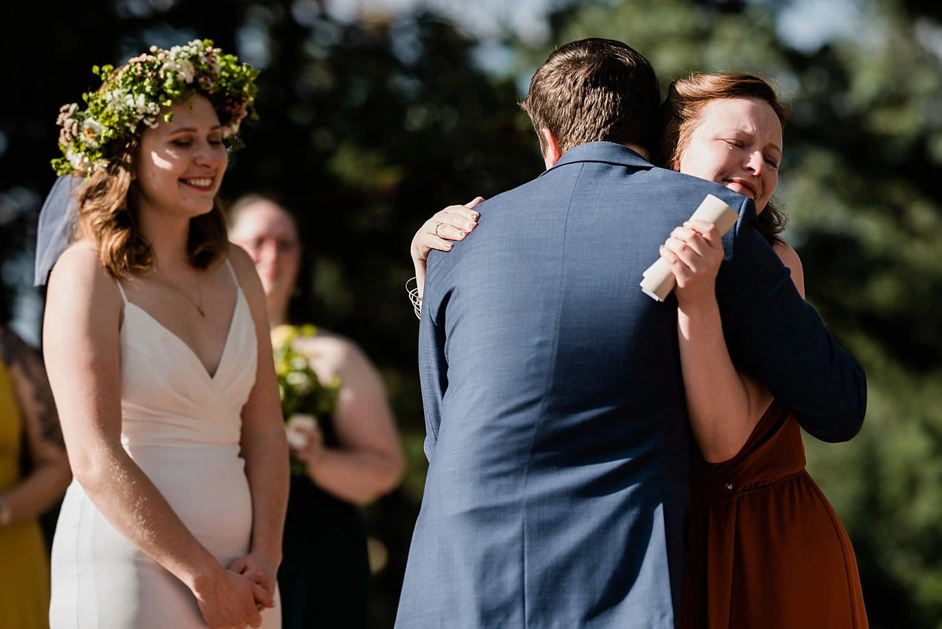 emotional hugs at outdoor Colorado wedding photo