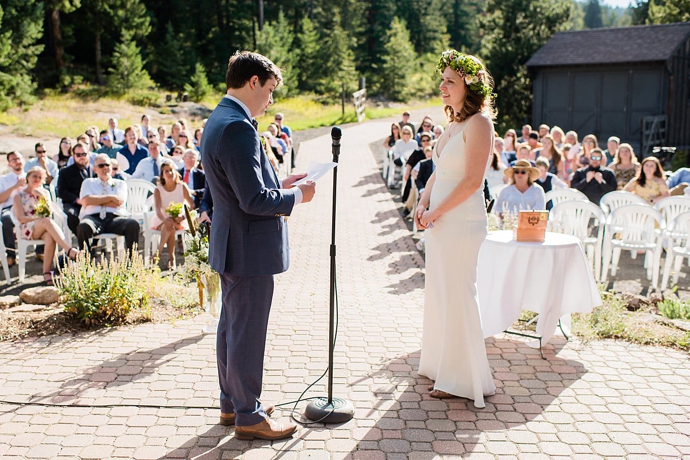 bride and groom say vows at Evergreen Red Barn wedding photo