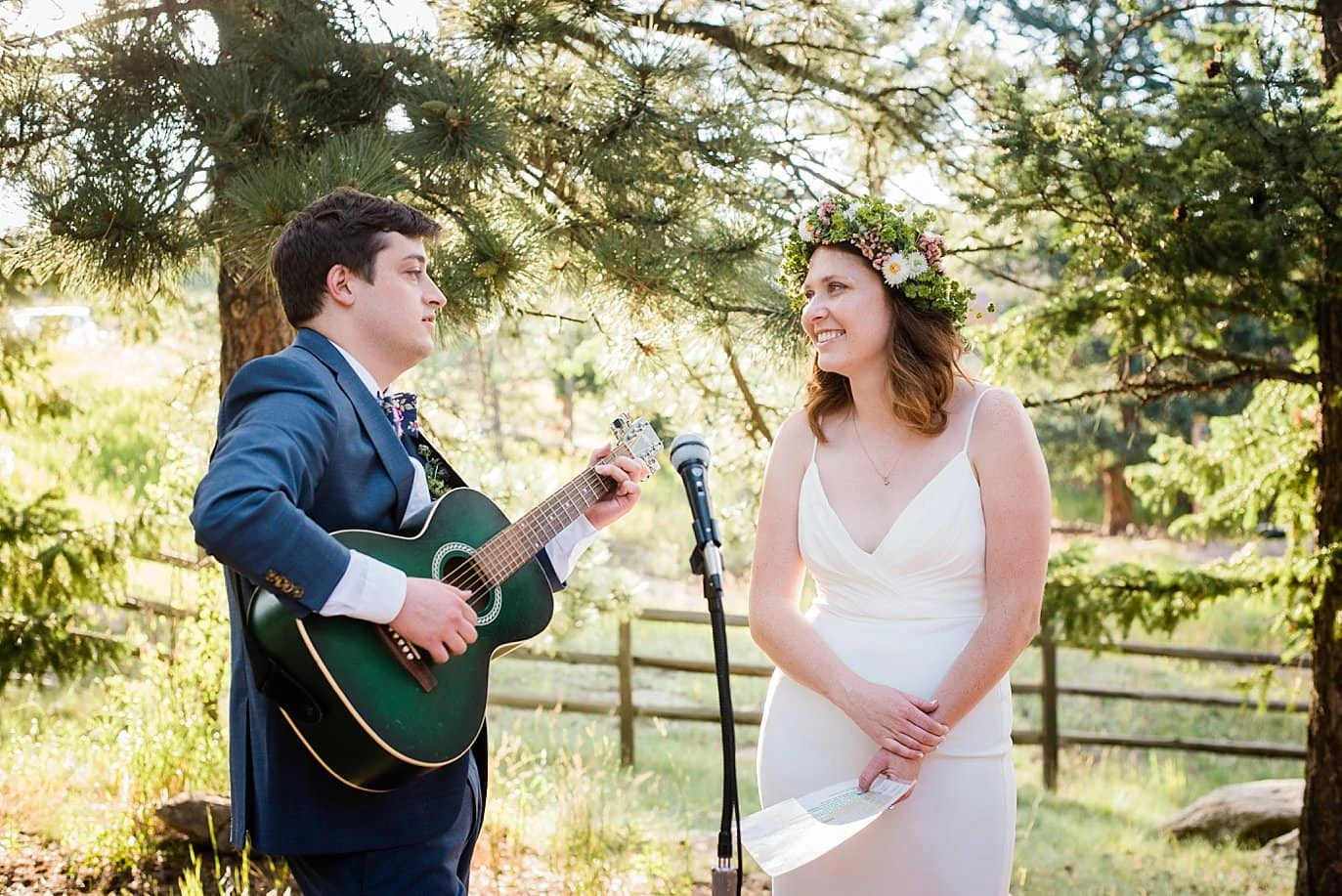 bride and groom sing John Prine song to each other at outdoor wedding reception photo