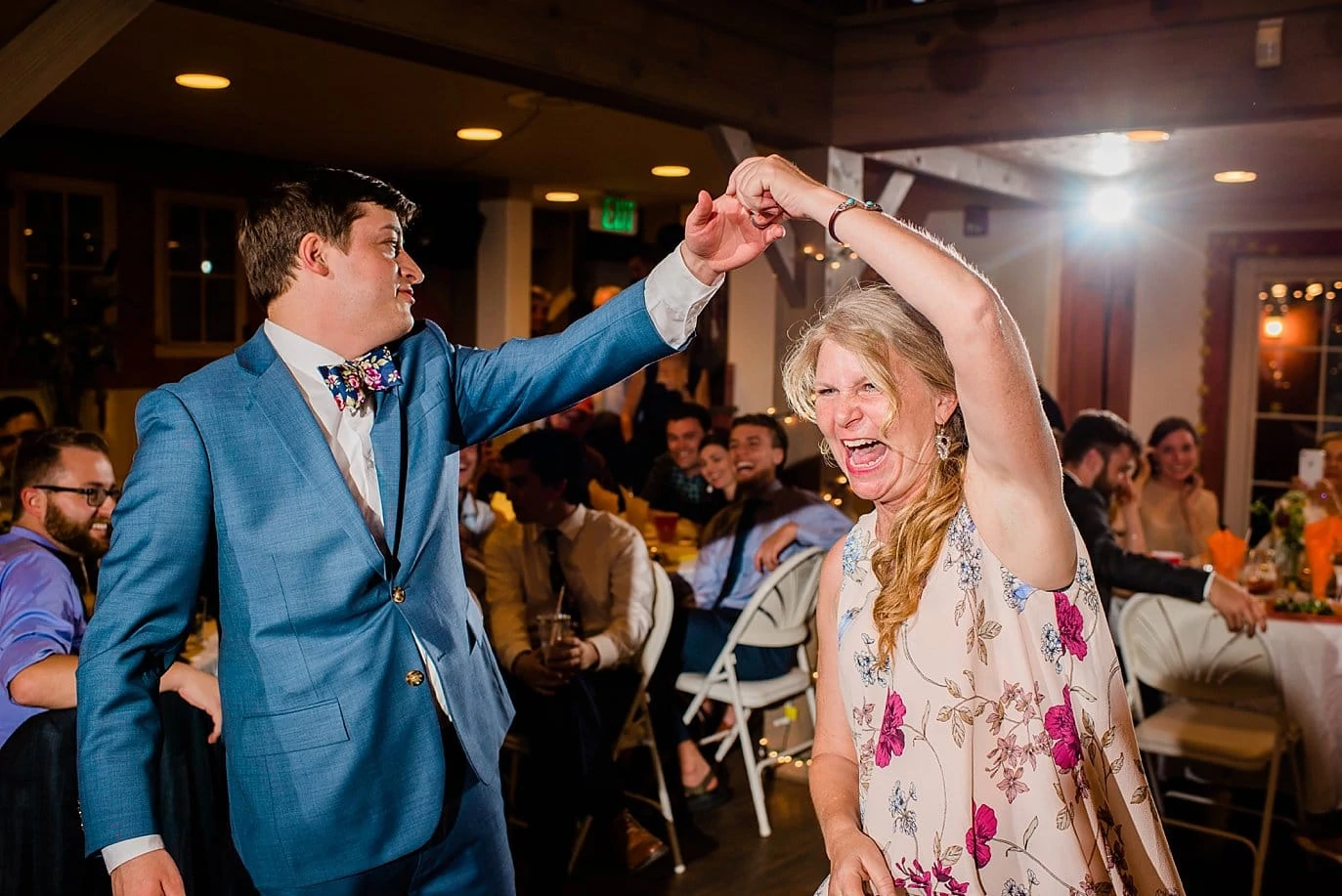 groom dances with mother of the bride photo