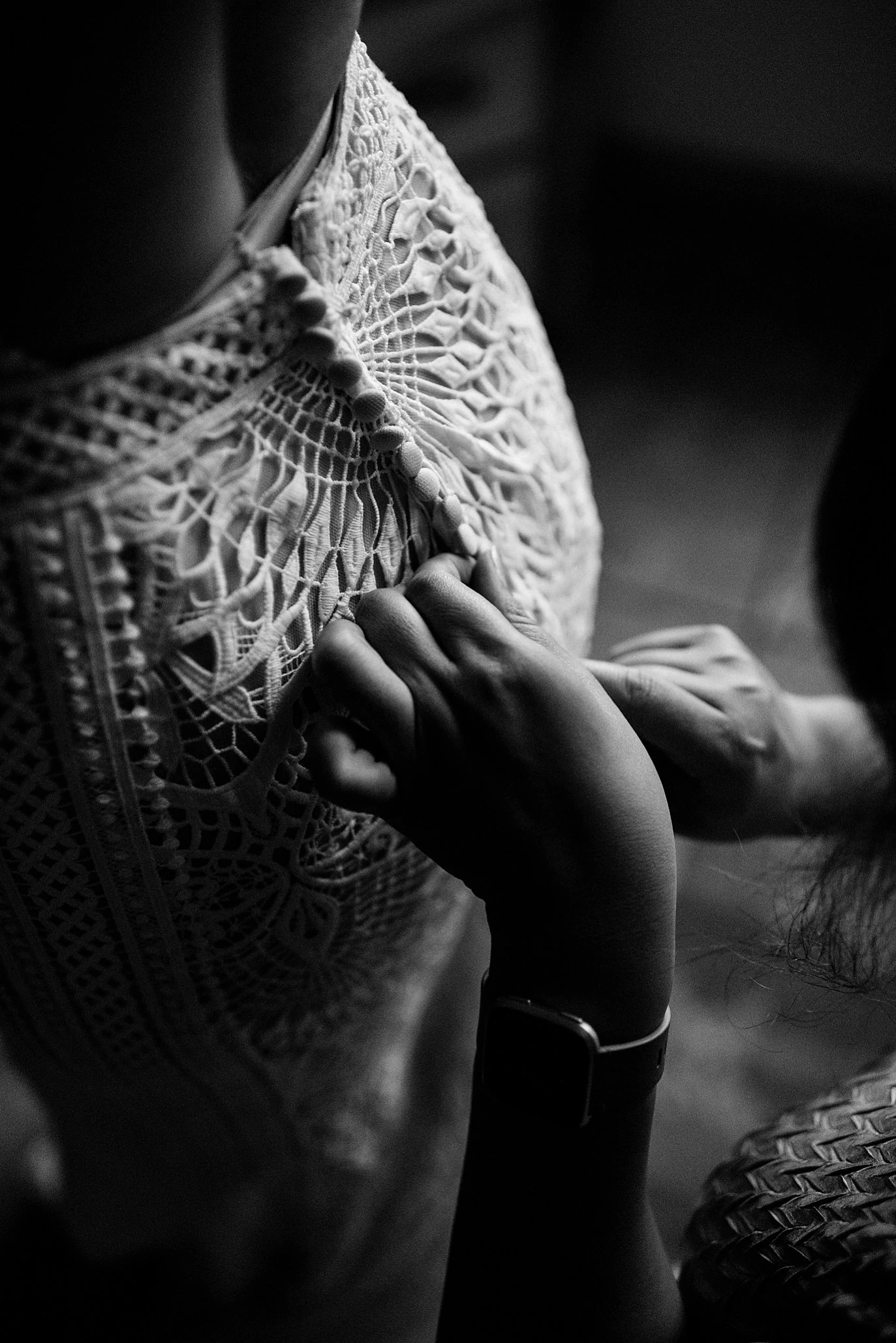 bride getting dress laced up photo