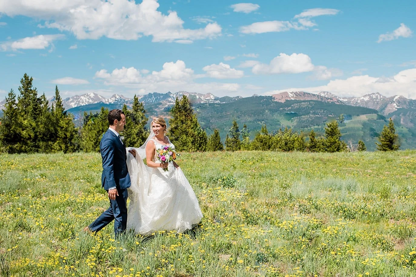 bride and groom at top of Vail Mountain summer wildflower photo