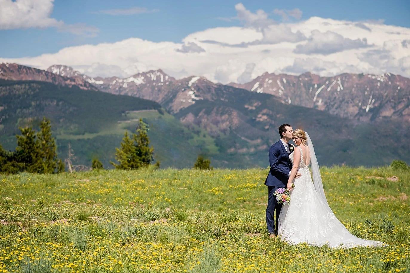 bride and groom on top of Vail Mountain at Sonnenalp Hotel wedding by Vail wedding photographer Jennie Crate