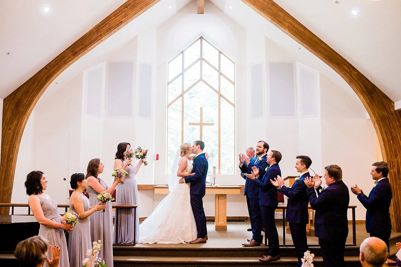first kiss Vail Interfaith Chapel summer wedding by Vail wedding photographer Jennie Crate