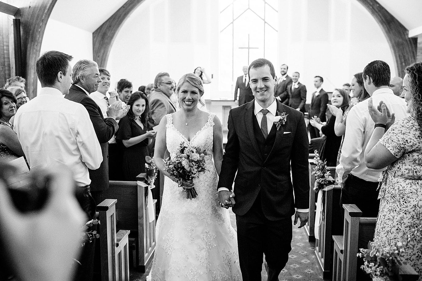 bride and groom just married in Vail Interfaith Chapel by Colorado wedding photographer Jennie Crate