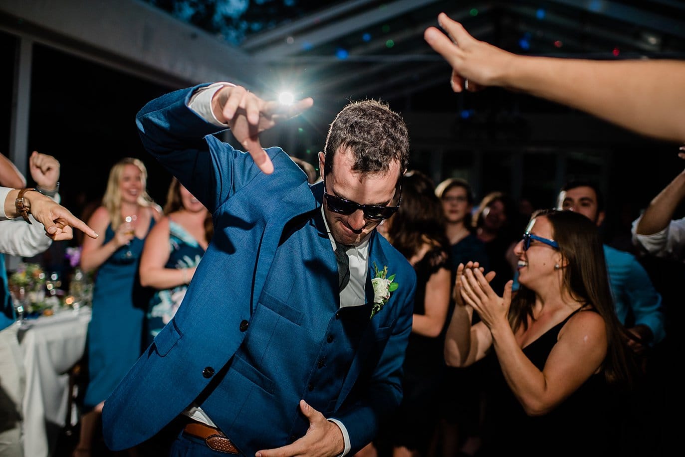 groom in sunglasses on dance floor at Summer Sonnenalp Hotel Vail wedding by Vail wedding photographer Jennie Crate