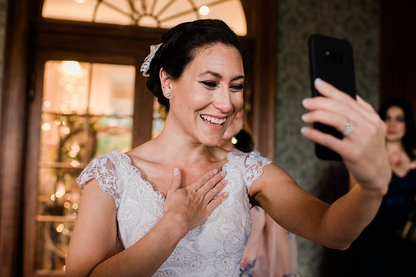bride doing FaceTime call with relatives on wedding day at The Stanley Hotel wedding by Estes Park wedding photographer Jennie Crate