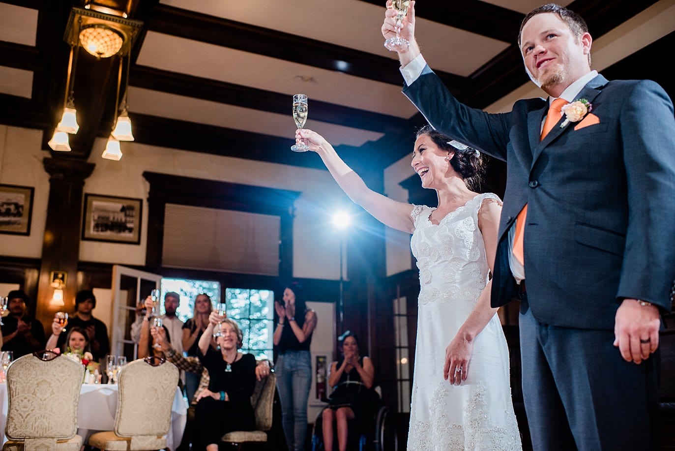 bride and groom toast guests at The Stanley Hotel wedding by Estes Park wedding photographer Jennie Crate