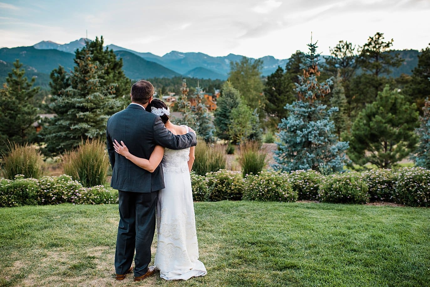 bride and groom watching sunset at The Stanley Hotel wedding by Estes Park wedding photographer Jennie Crate