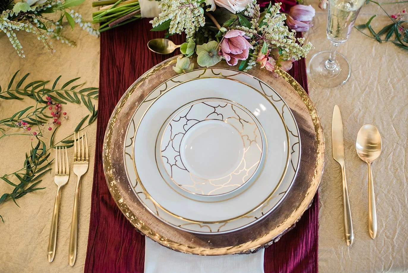 gold flatware and silverware with burgundy table runner at at Northgate Event Center wedding by Thornton wedding photographer Jennie Crate