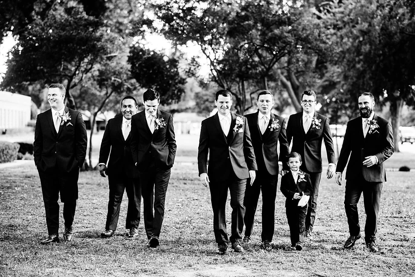 groom and groomsmen walk at church before Wichita Falls wedding