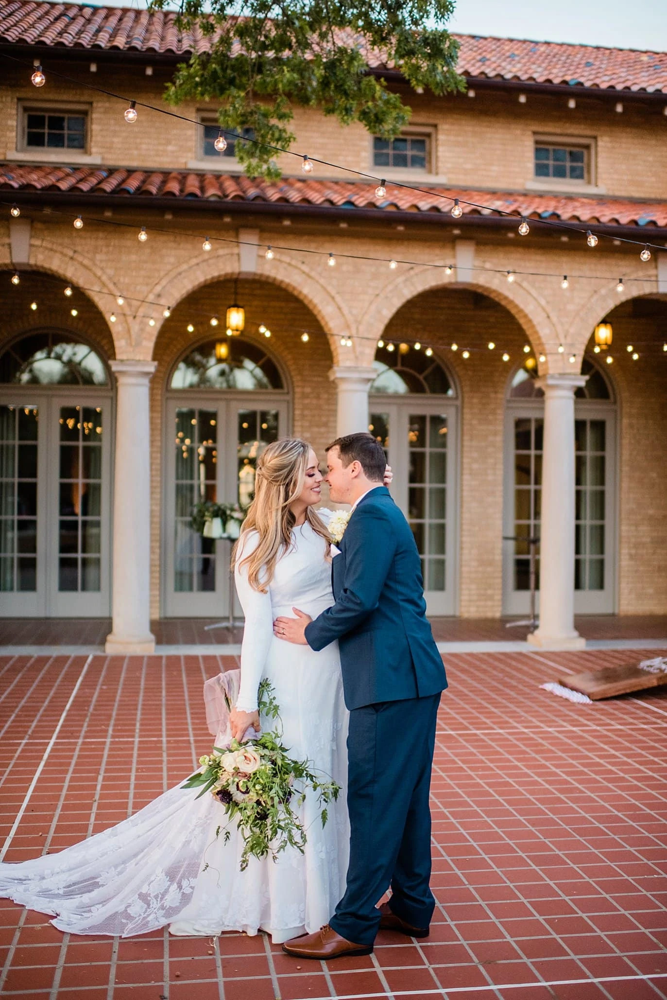bride and groom under the market lights at The Forum Wichita Falls Texas wedding by Wichita Falls wedding photographer Jennie Crate