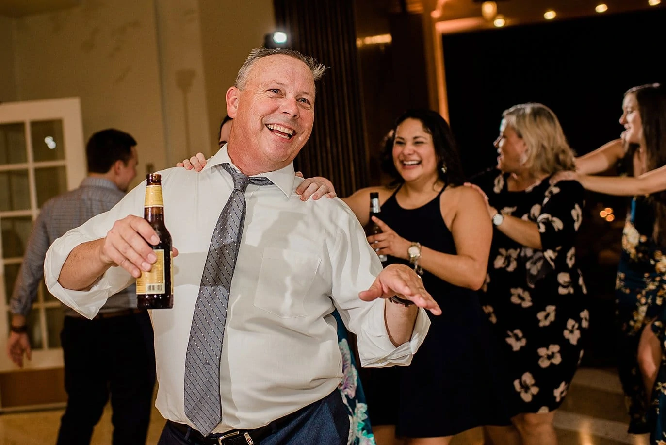 father of the groom congo line at The Forum Wichita Falls wedding by Austin wedding photographer Jennie Crate