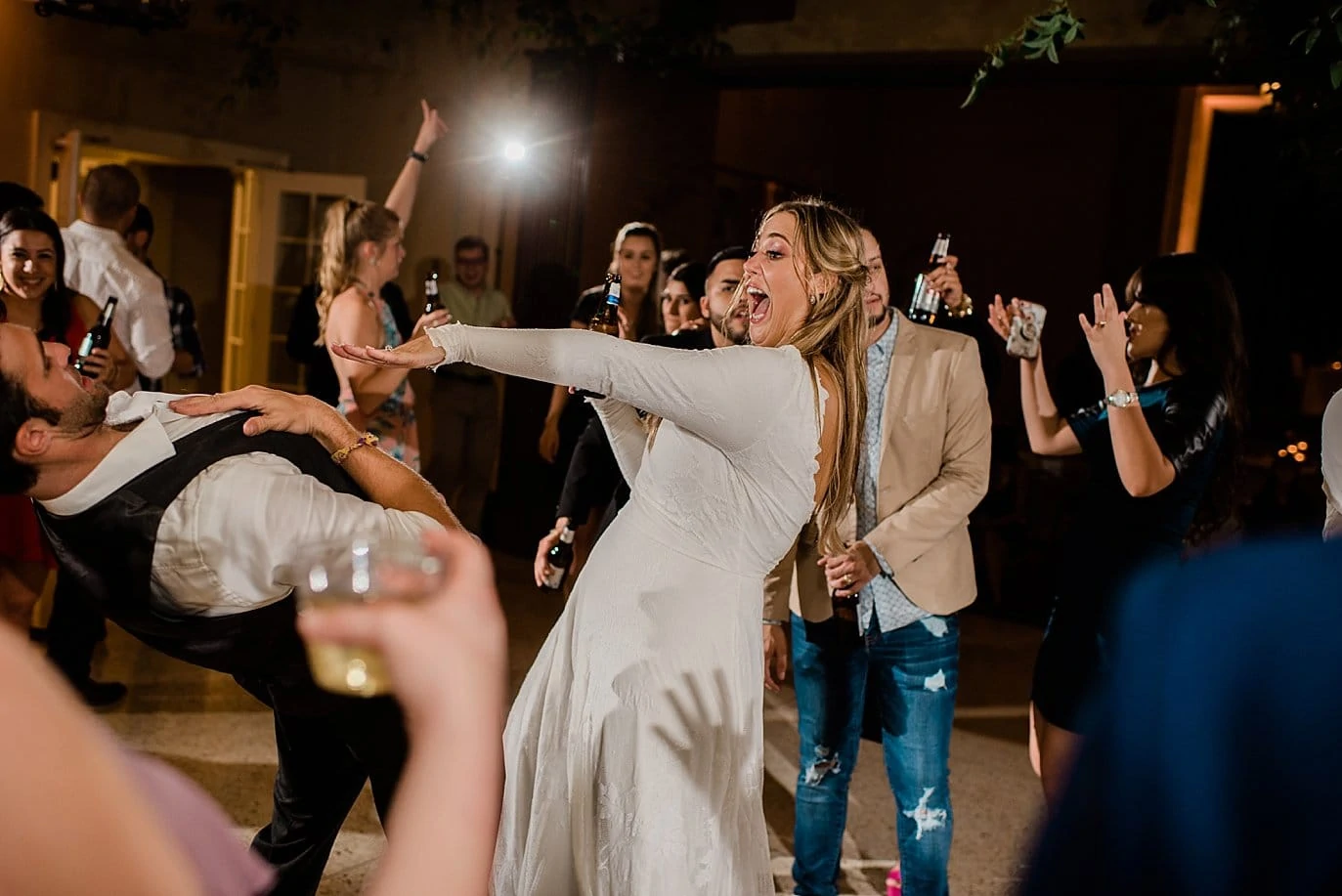 bride breaking it down on the dance floor in wedding dress at The Forum Wichita Falls wedding by Texas wedding photographer Jennie Crate