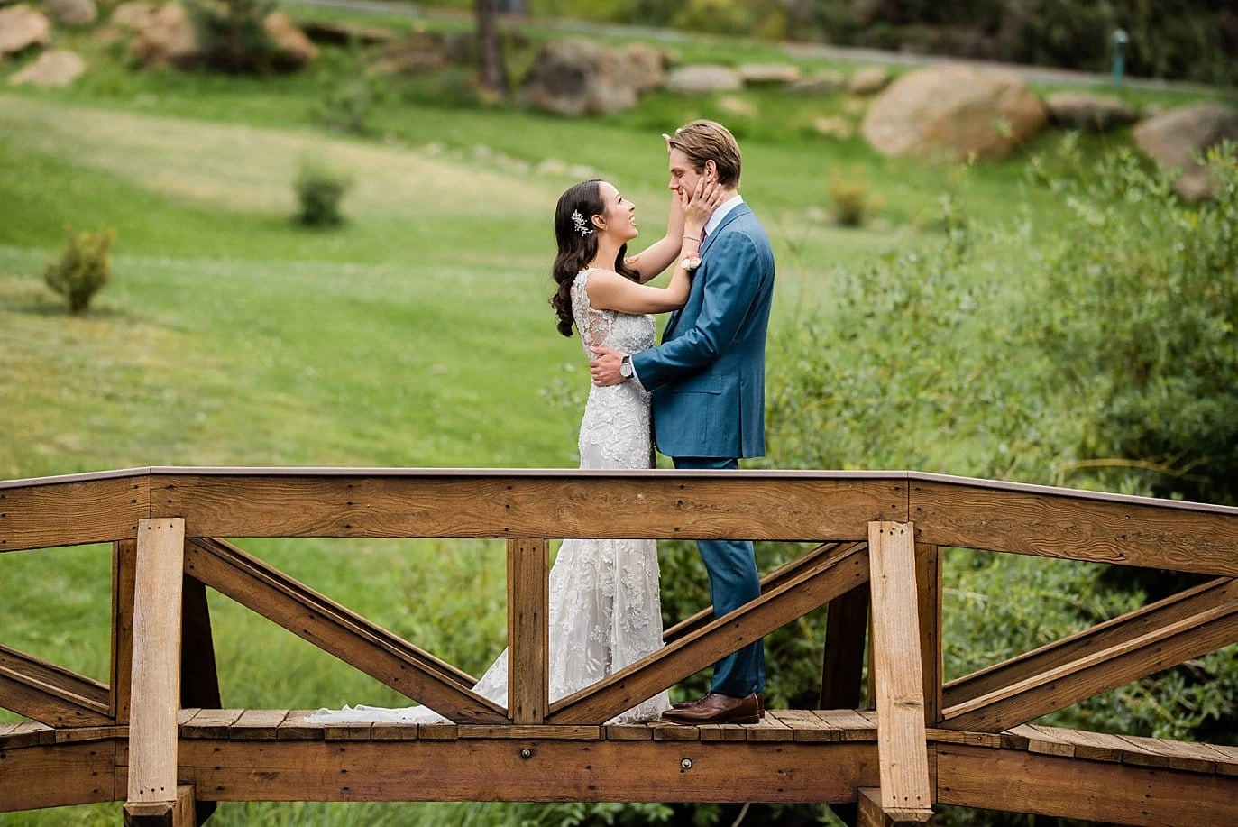 first look on bridge over pond at Black Canyon Inn wedding by Lyons wedding photographer Jennie Crate Photographer