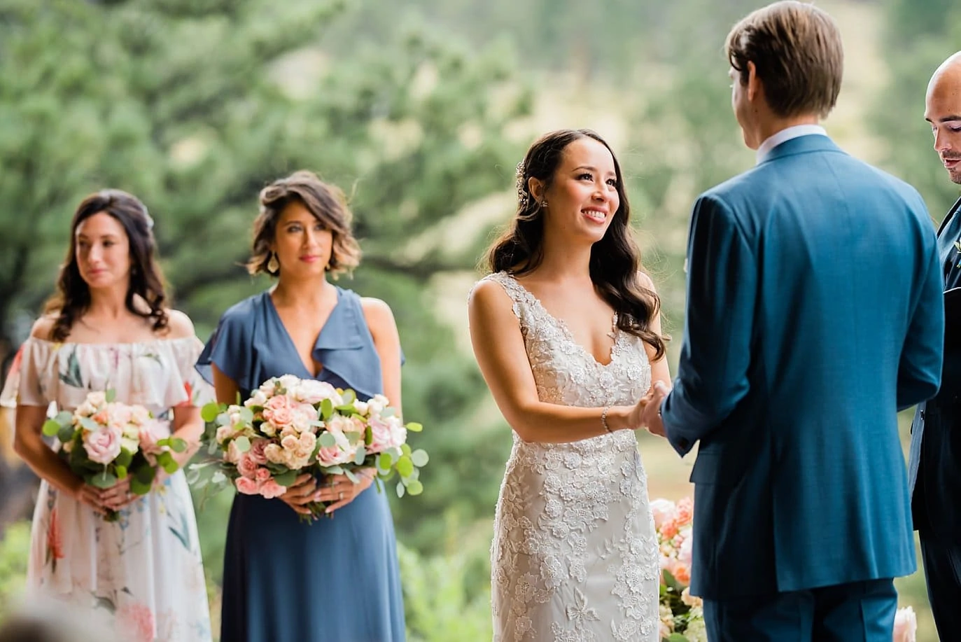 bride smiles at groom during outdoor wedding ceremony at Black Canyon Inn wedding by Denver wedding photographer Jennie Crate Photographer