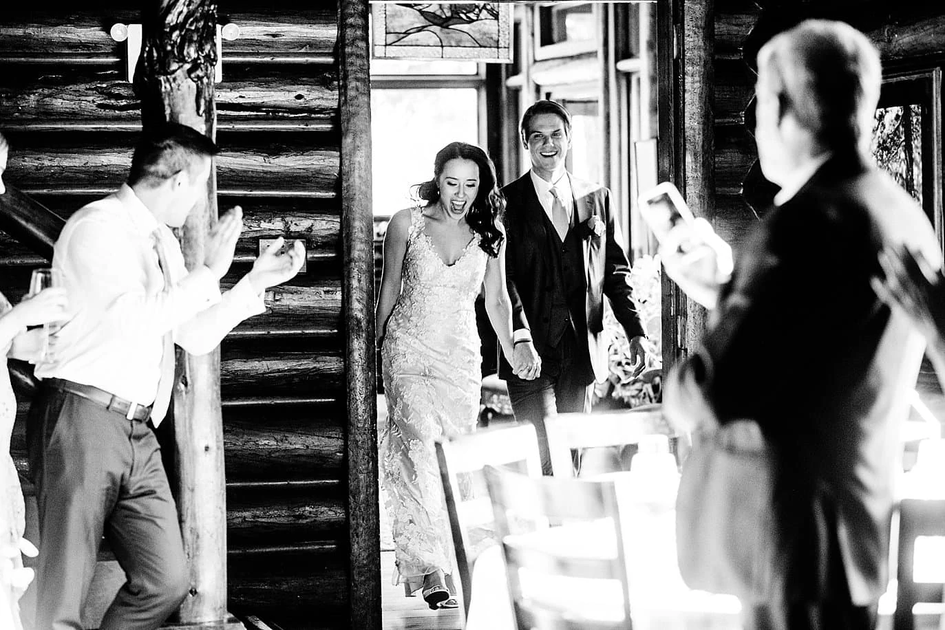 bride and groom grand entrance into reception at t Twin Owls Steakhouse wedding by Lyons wedding photographer Jennie Crate photographer
