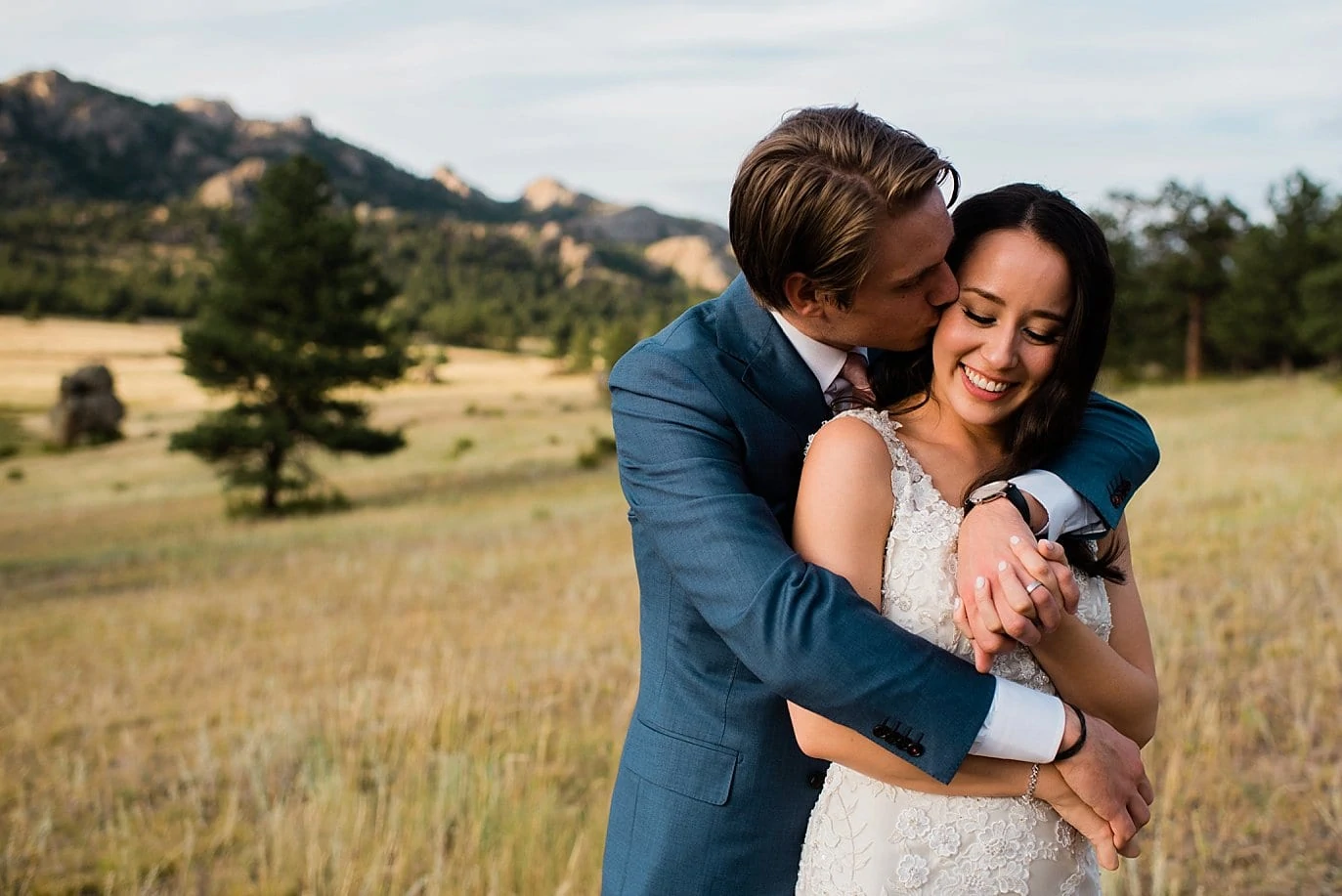 intimate sunset portrait of bride and groom in field of Estes Park at t Twin Owls Steakhouse wedding by Fort Collins wedding photographer Jennie Crate photographer