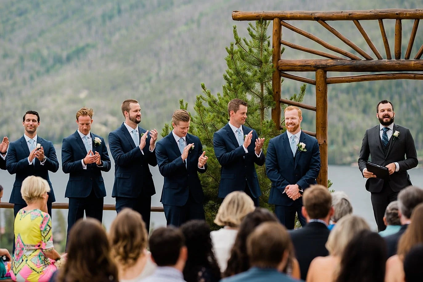 groom gets cheered at alter of wedding ceremony at Grand Lake Lodge wedding by Boulder wedding photographer Jennie Crate