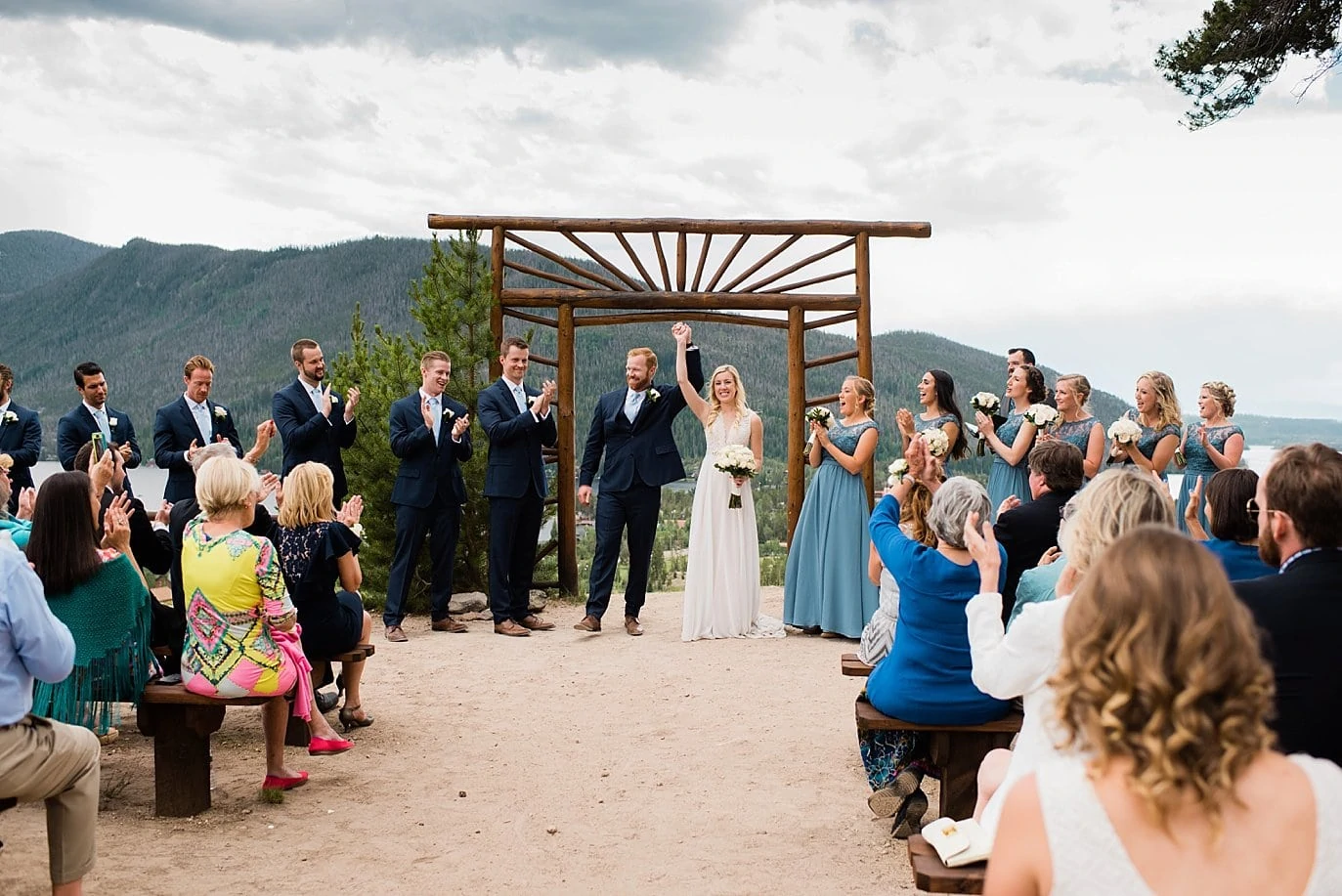 bride and groom celebrate being announced married at Grand Lake Lodge wedding by Estes Park wedding photographer Jennie Crate