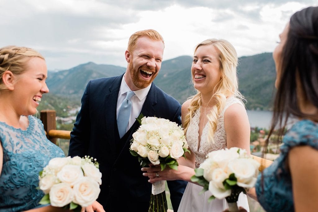 bride and groom laugh after wedding ceremony at Grand Lake Lodge wedding by Granby wedding photographer Jennie Crate