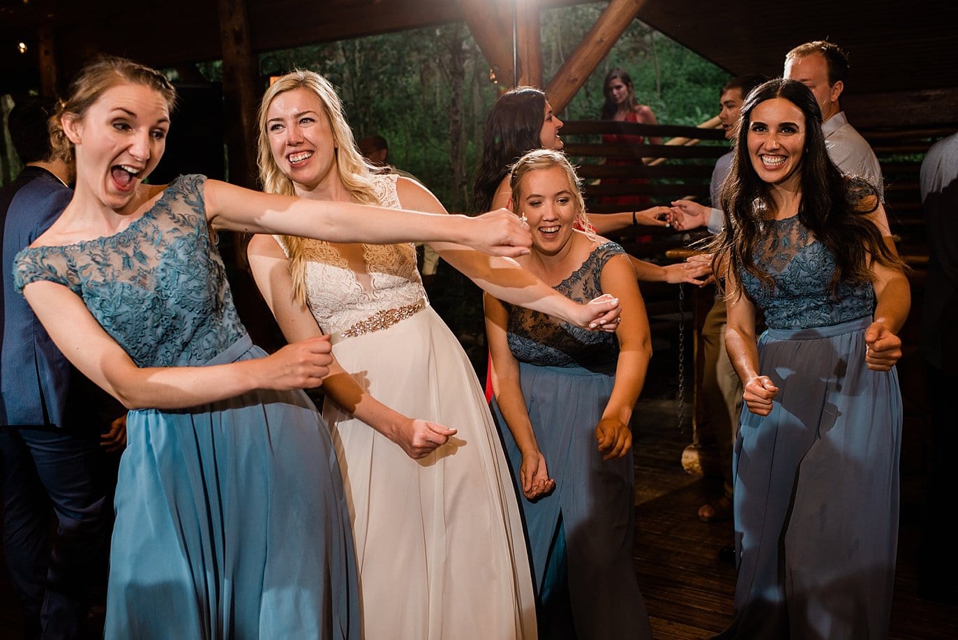 bride and bridesmaids dance at Grand Lake Lodge wedding by Grand Lake wedding photographer Jennie Crate Photographer