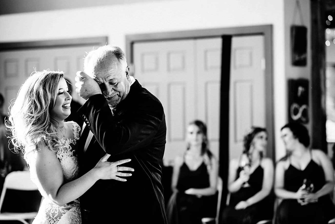 bride's father wipes away tears during father daughter dance at at Pagosa Springs wedding by Denver Wedding Photographer Jennie Crate