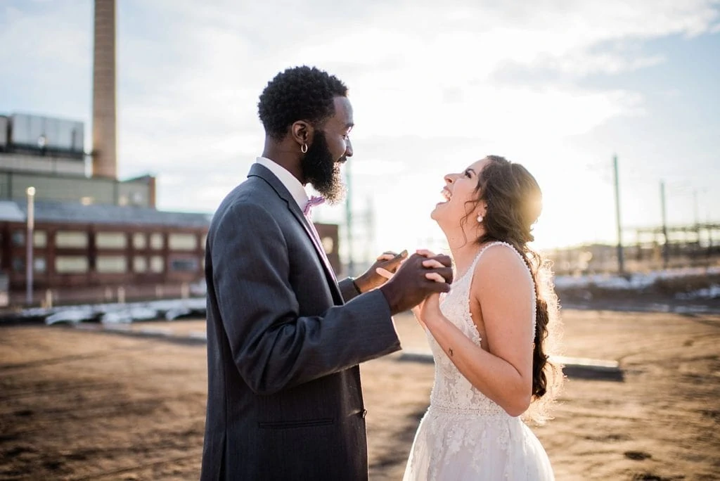 bride and groom laughing in sunset light at Shyft Denver wedding by Denver wedding photographer Jennie Crate