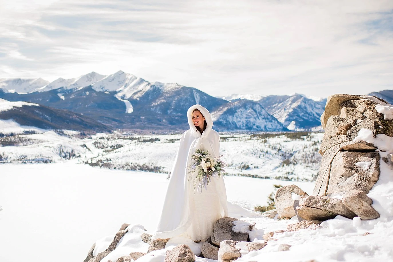 bride in white winter cape over wedding dress at Sapphire Point Elopement by keystone wedding photographer Jennie Crate Photographer