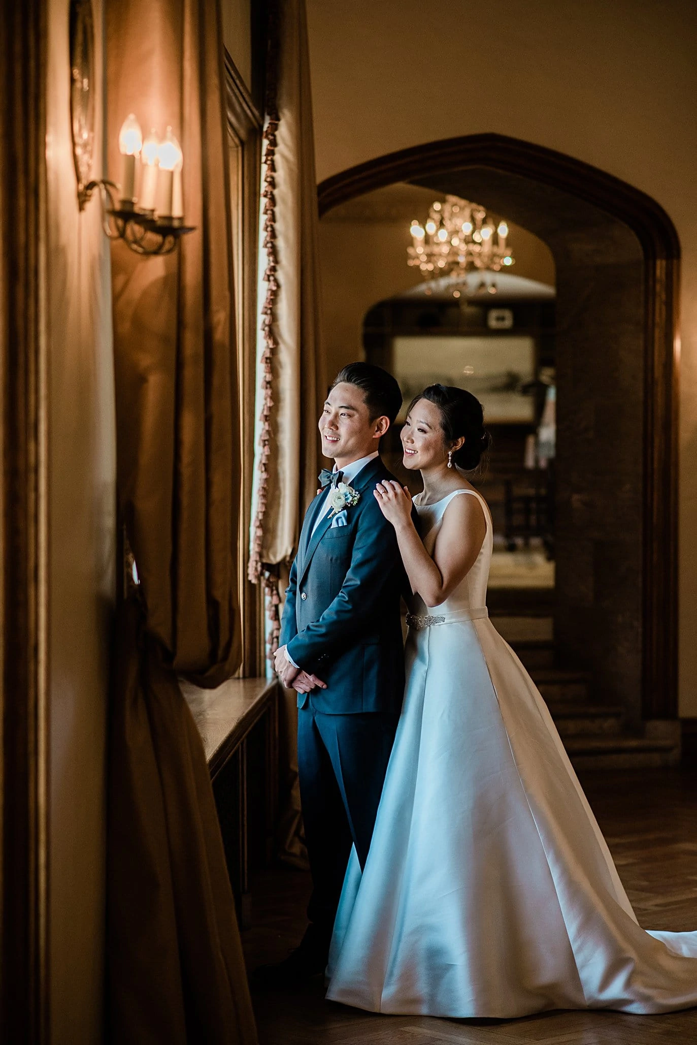 bride and groom by window in parlor at Highlands Ranch Mansion wedding by Denver wedding photographer Jennie Crate