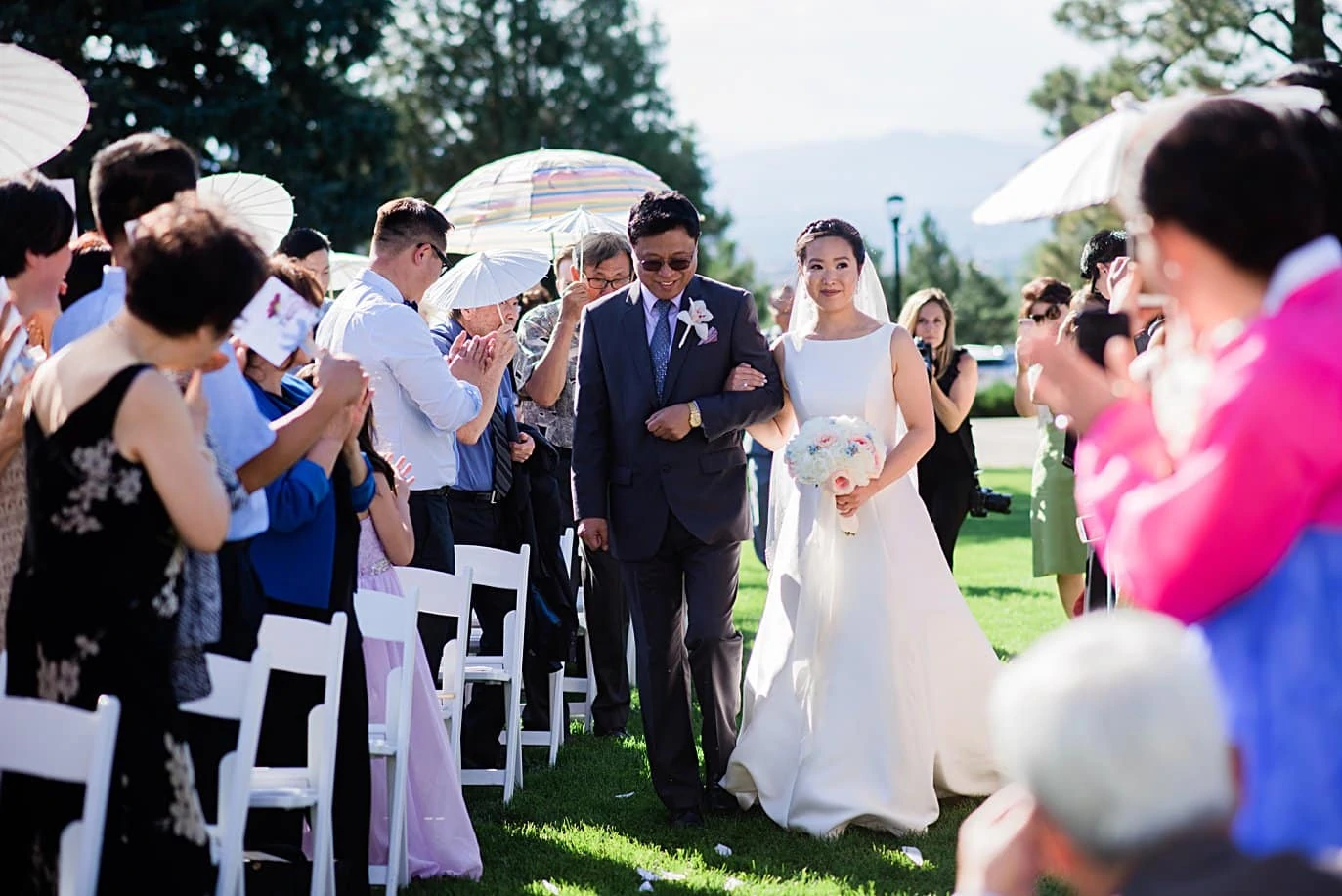 bride and father walk down aisle at Highlands Ranch Mansion wedding by Boulder wedding photographer Jennie Crate