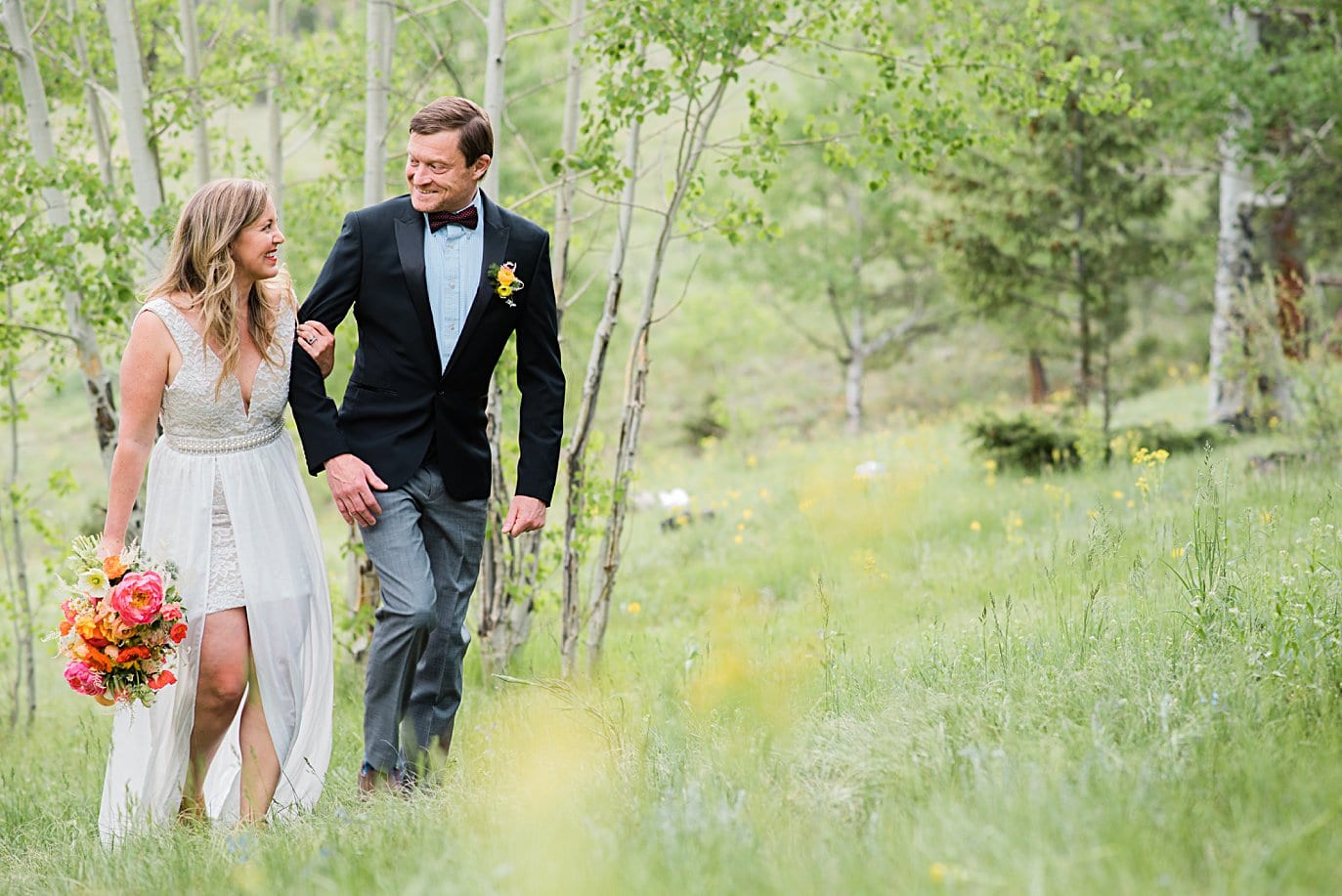 couple walks in aspen grove at private Golden elopement by Boulder wedding photographer Jennie Crate