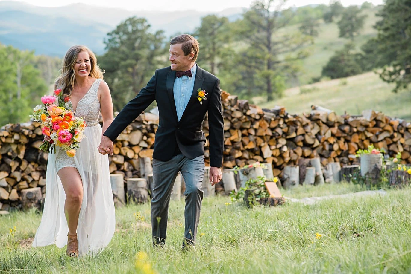 bride and groom walk hand in hand from outdoor ceremony at private Golden elopement by Boulder elopement photographer Jennie Crate