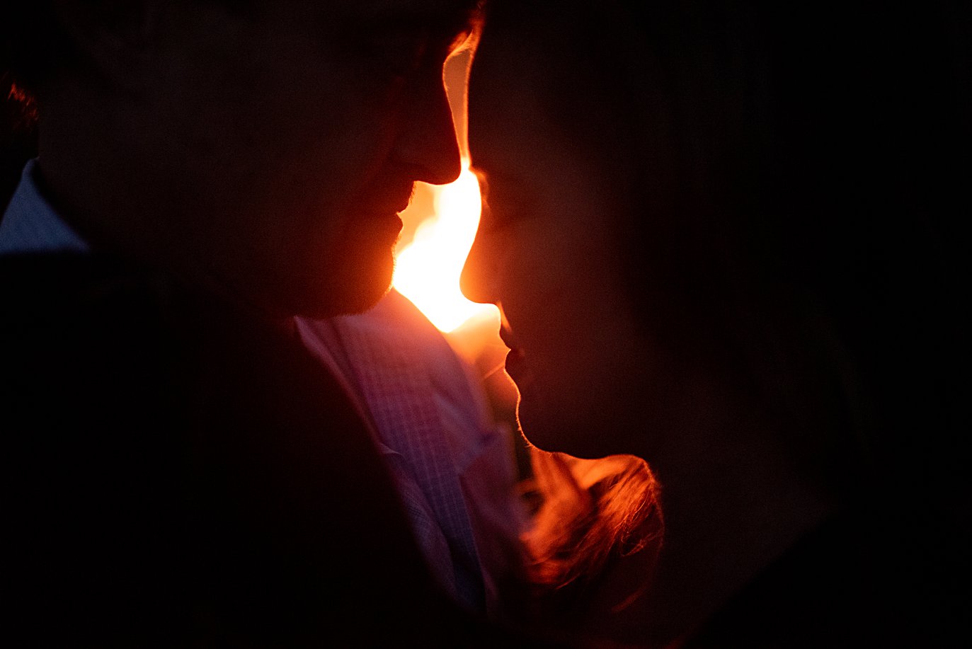romantic silhouette by firepit at private Golden elopement by Boulder wedding photographer Jennie Crate