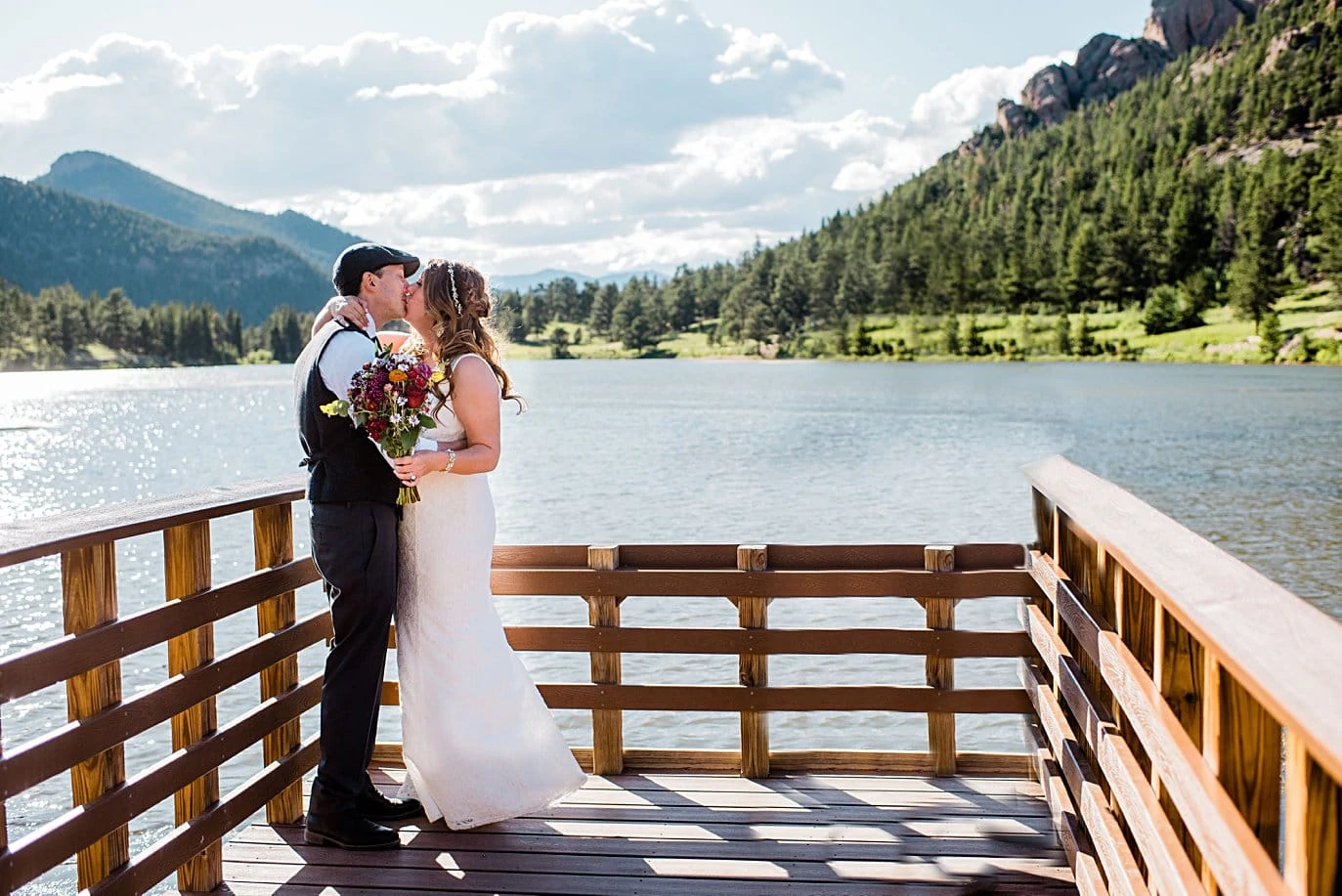 bride and groom first kiss at Lily Lake Elopement by Estes Park elopement photographer Jennie Crate