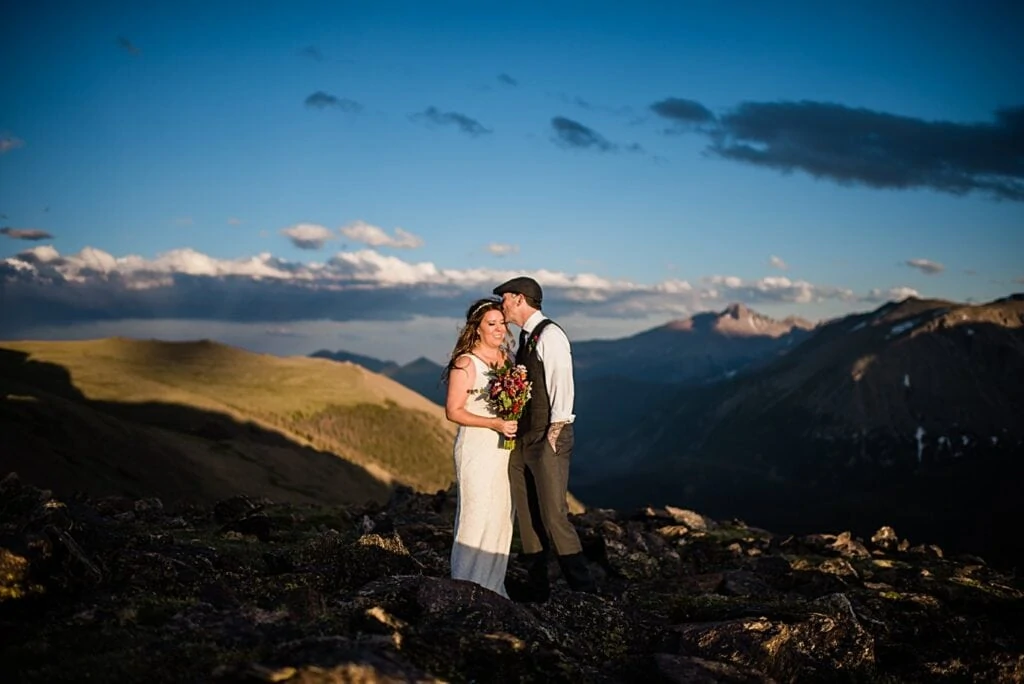 bride and groom wedding day portrait with Longs Peak at Rocky Mountain National Park elopement by Boulder elopement photographer Jennie Crate