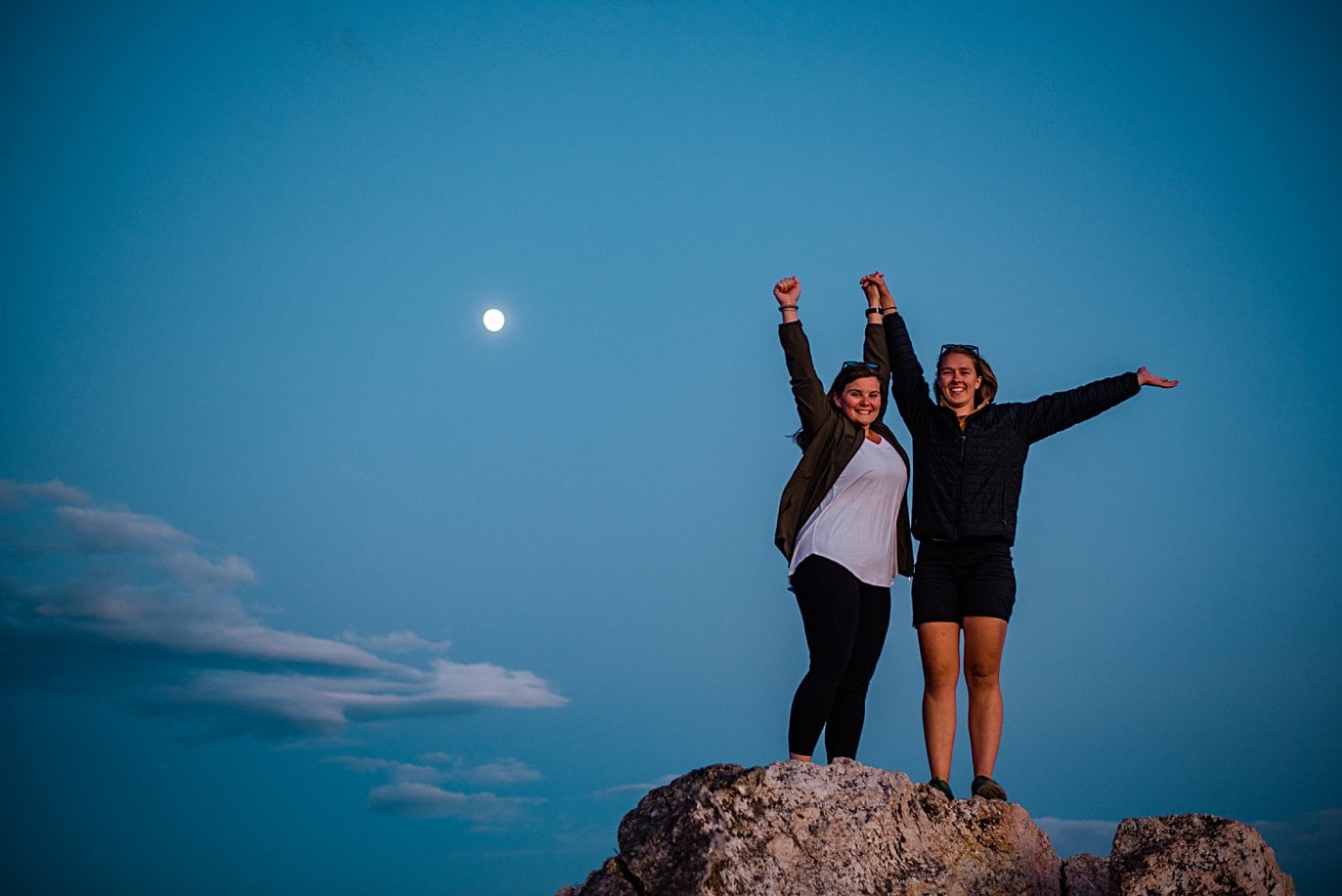 newly engaged brides celebrate at twilight at Rocky Mountain National Park engagement session by Colorado Gay Wedding photographer Jennie Crate