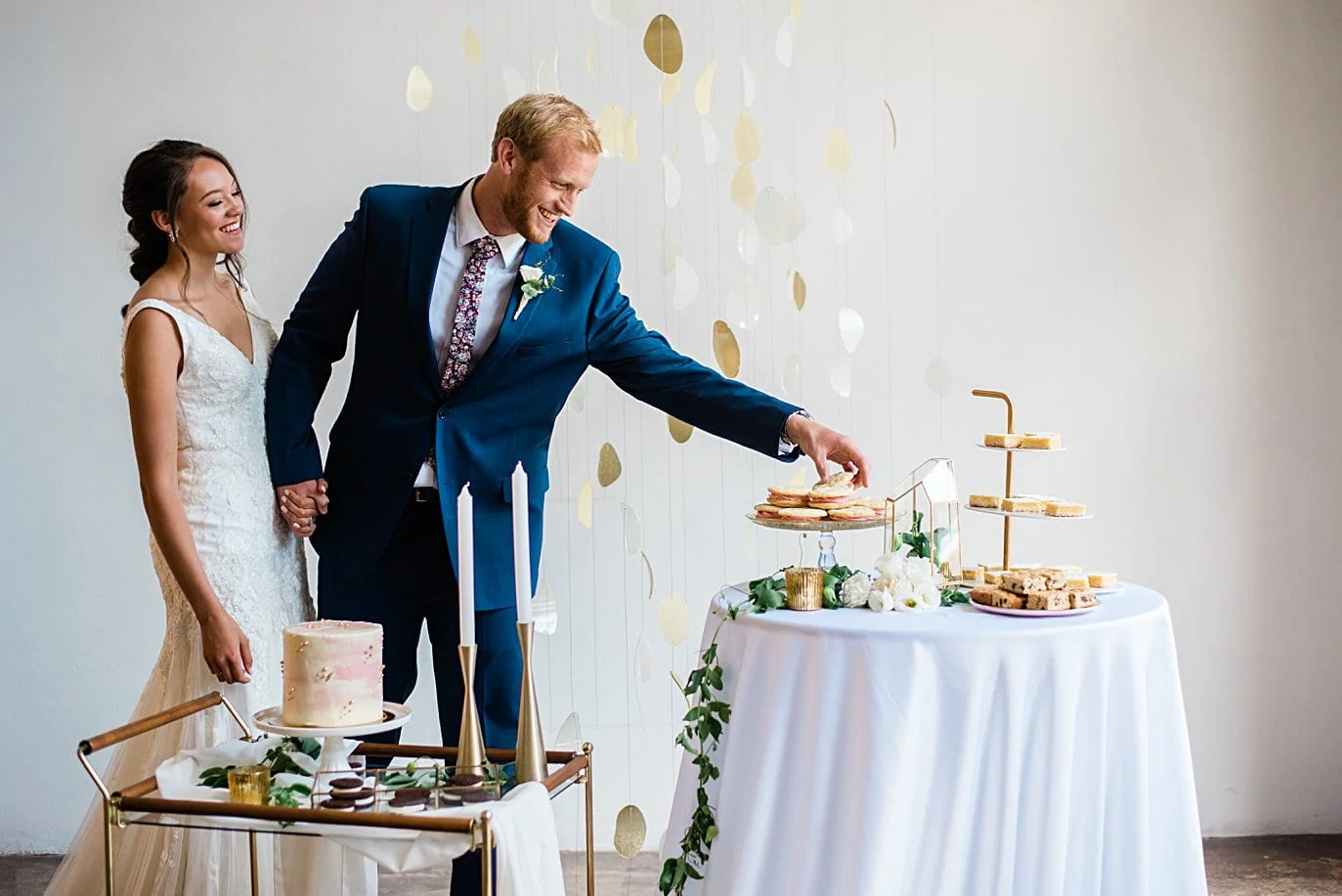 bride and groom grab desserts from dessert station at Walker Fine Art Gallery Wedding by Boulder Wedding Photographer Jennie Crate