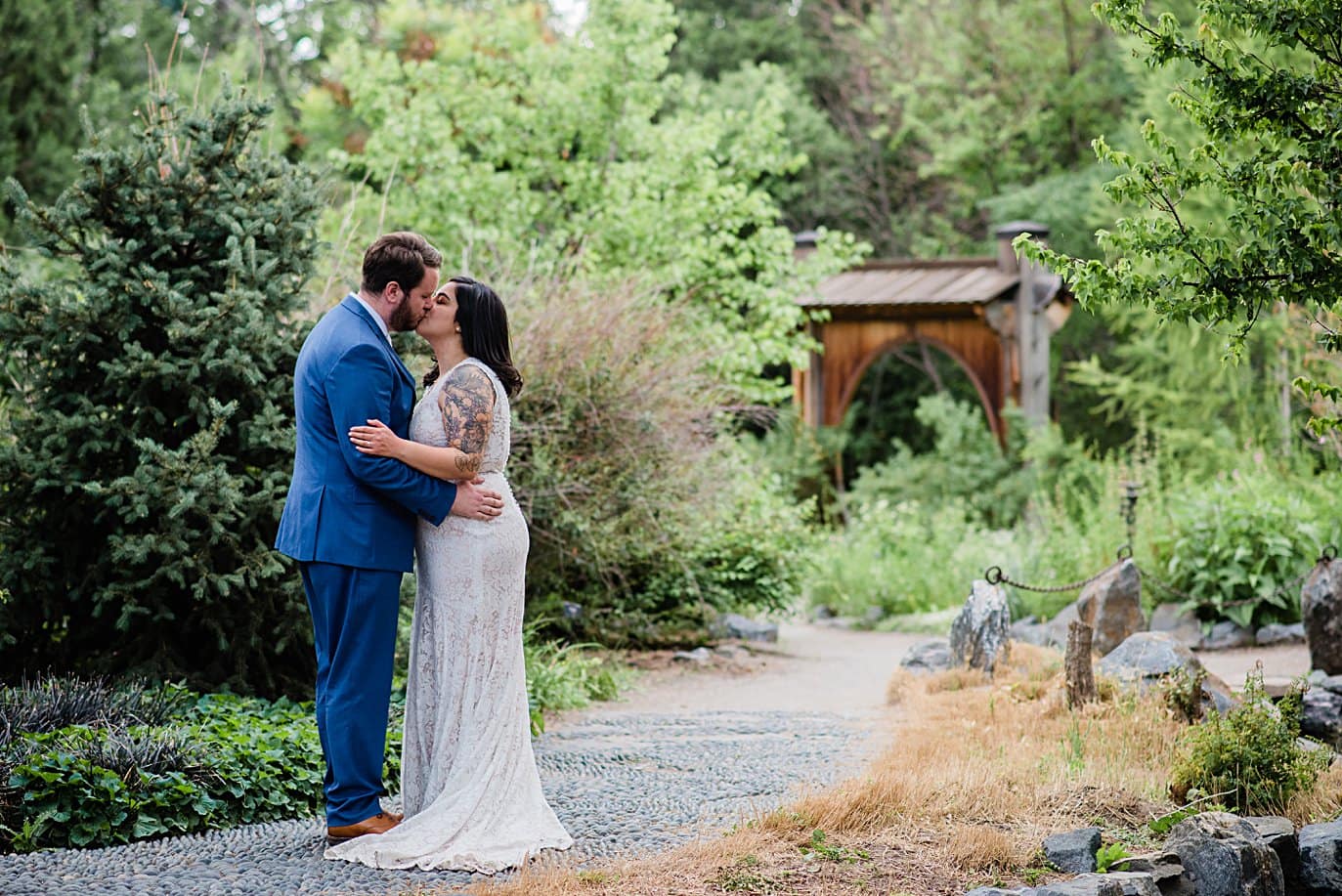 bride and groom walk in June's Plantasia at Denver Botanic Gardens wedding by Boulder Wedding Photographer Jennie Crate