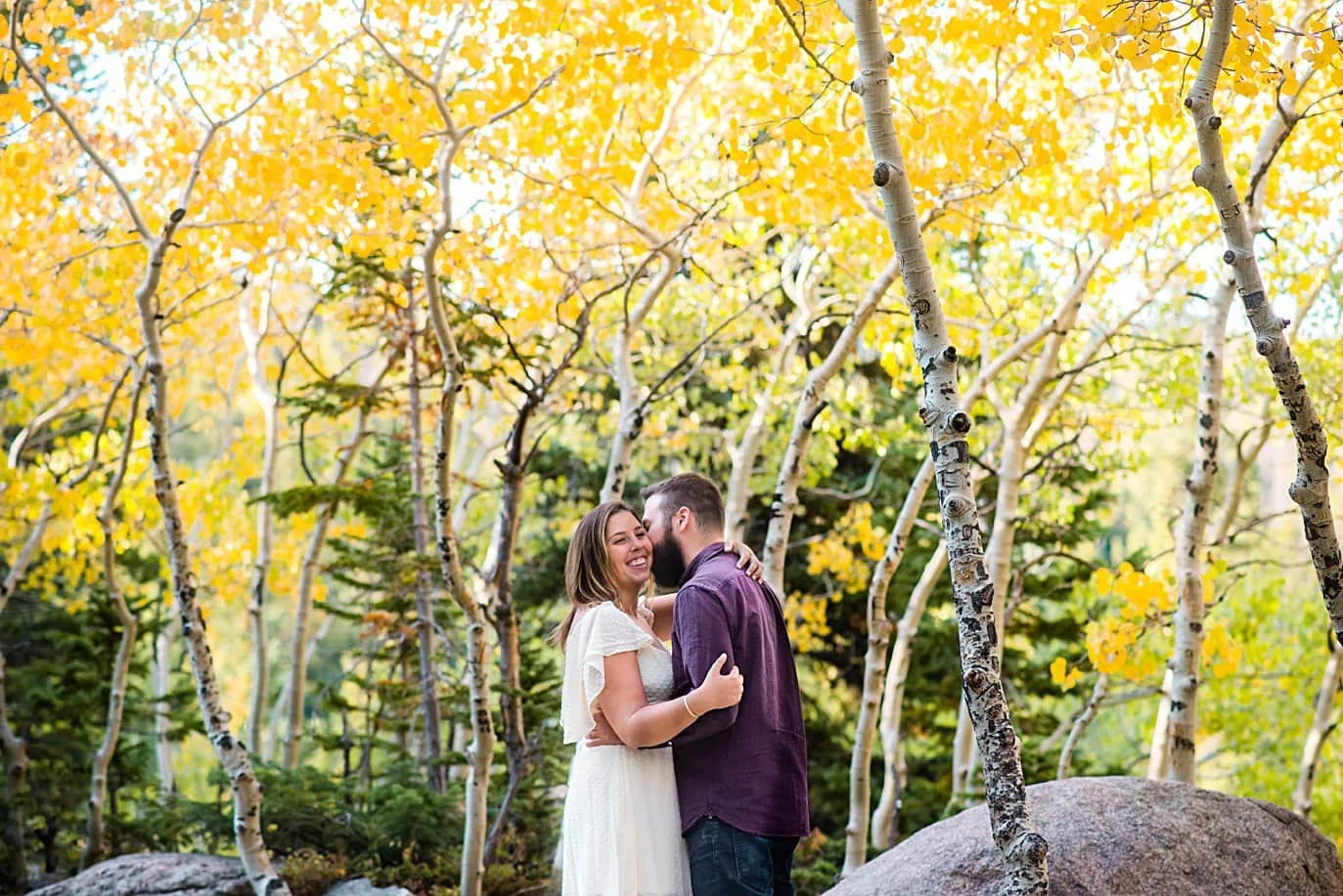 couple kisses in aspen grove in RMNP at Alberta falls engagement session by Estes Park engagement photographer Jennie Crate