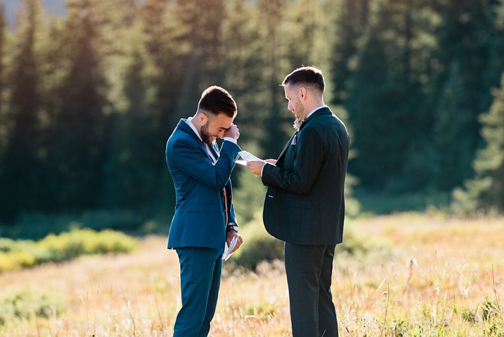 two grooms in custom suits share emotional vows at Breckenridge Elopement by Colorado gay wedding photographer Jennie Crate