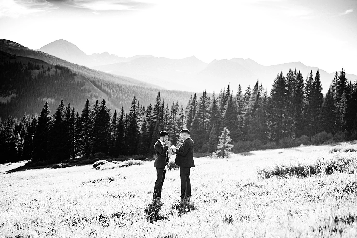 two grooms exchange vows in meadow at Breckenridge Elopement by Colorado gay wedding photographer Jennie Crate
