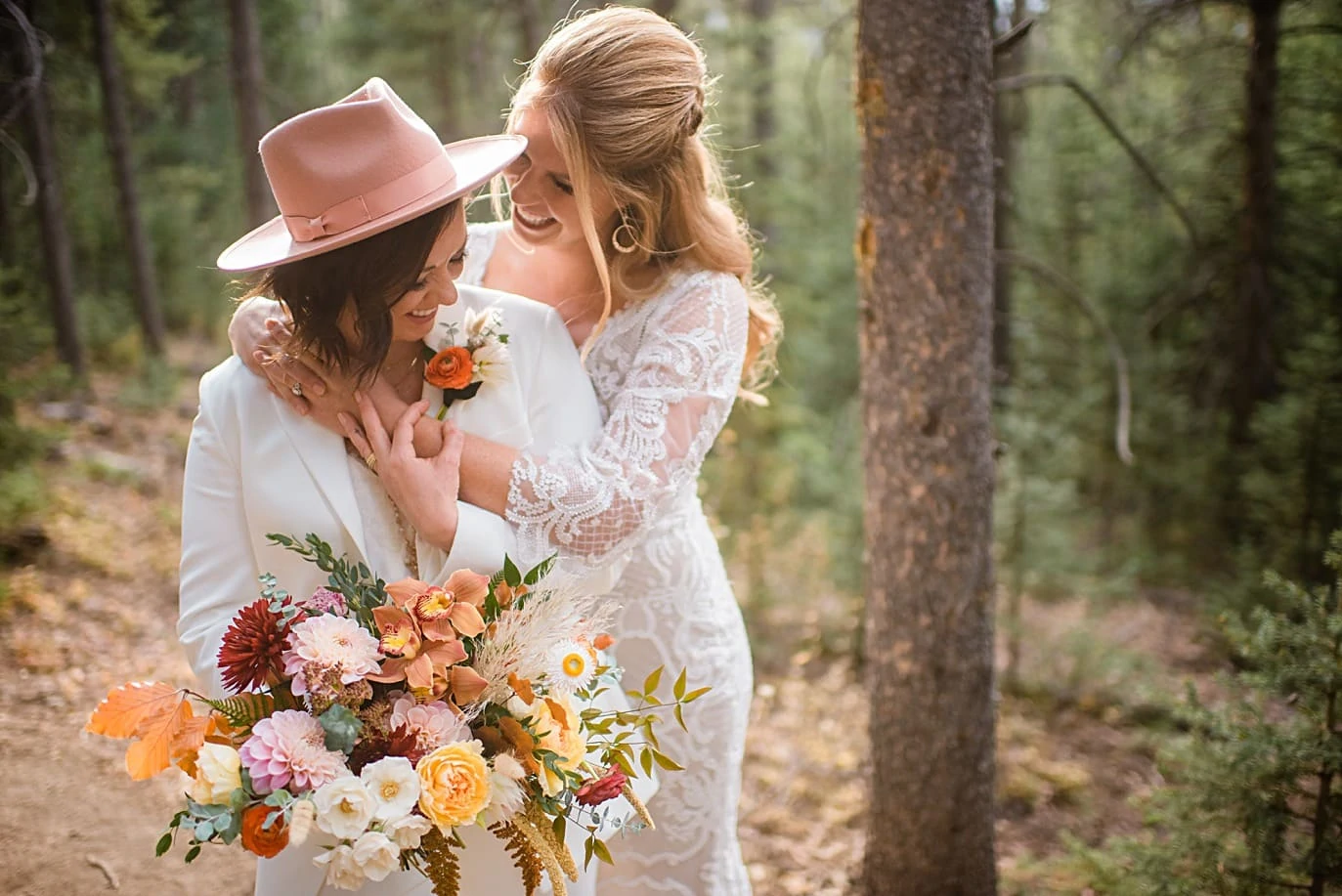 bride in pink hat at Breckenridge microwedding by Colorado LGBT wedding photographer Jennie Crate