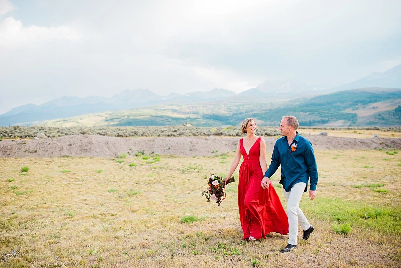 non-traditional red wedding dress at broken anter ranch wedding by silverthorne wedding photographer jennie crate