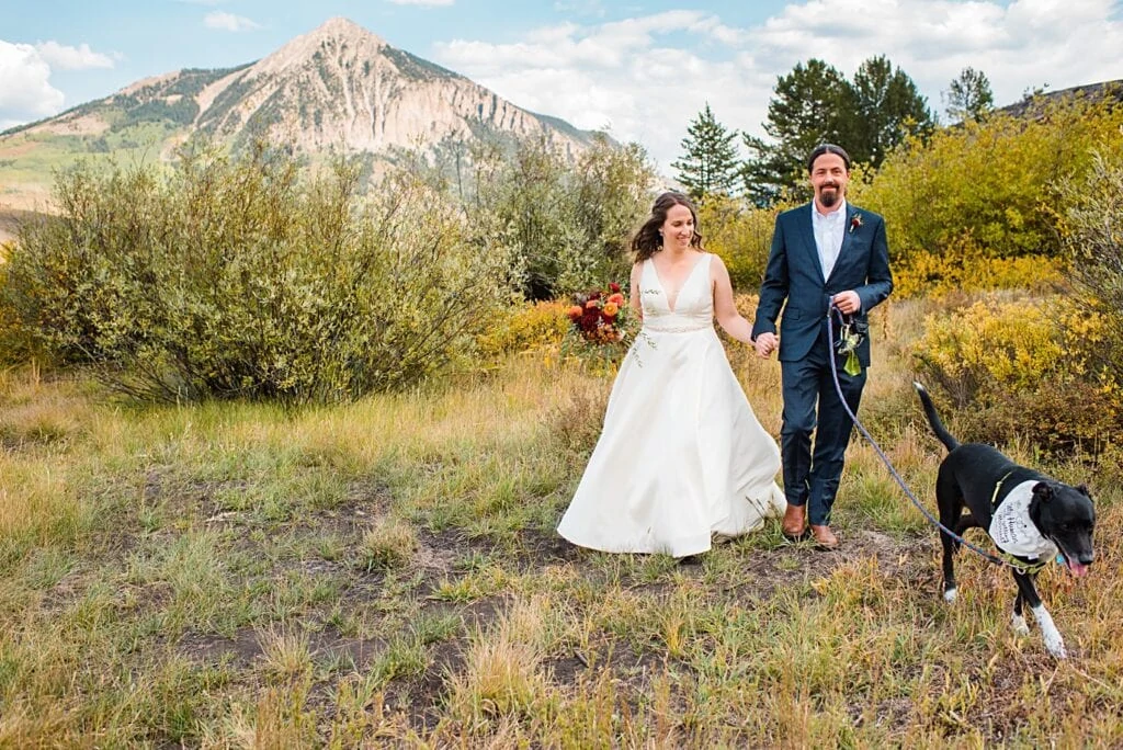 bride and groom walk hand in hand at peanut lake after first look at Crested Butte Elopement by Crested Butte elopement photographer Jennie Crate