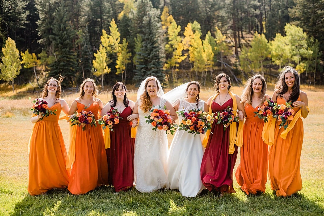 bridal party in field at fall Deer Creek Valley Ranch wedding by Denver wedding photographer Jennie Crate