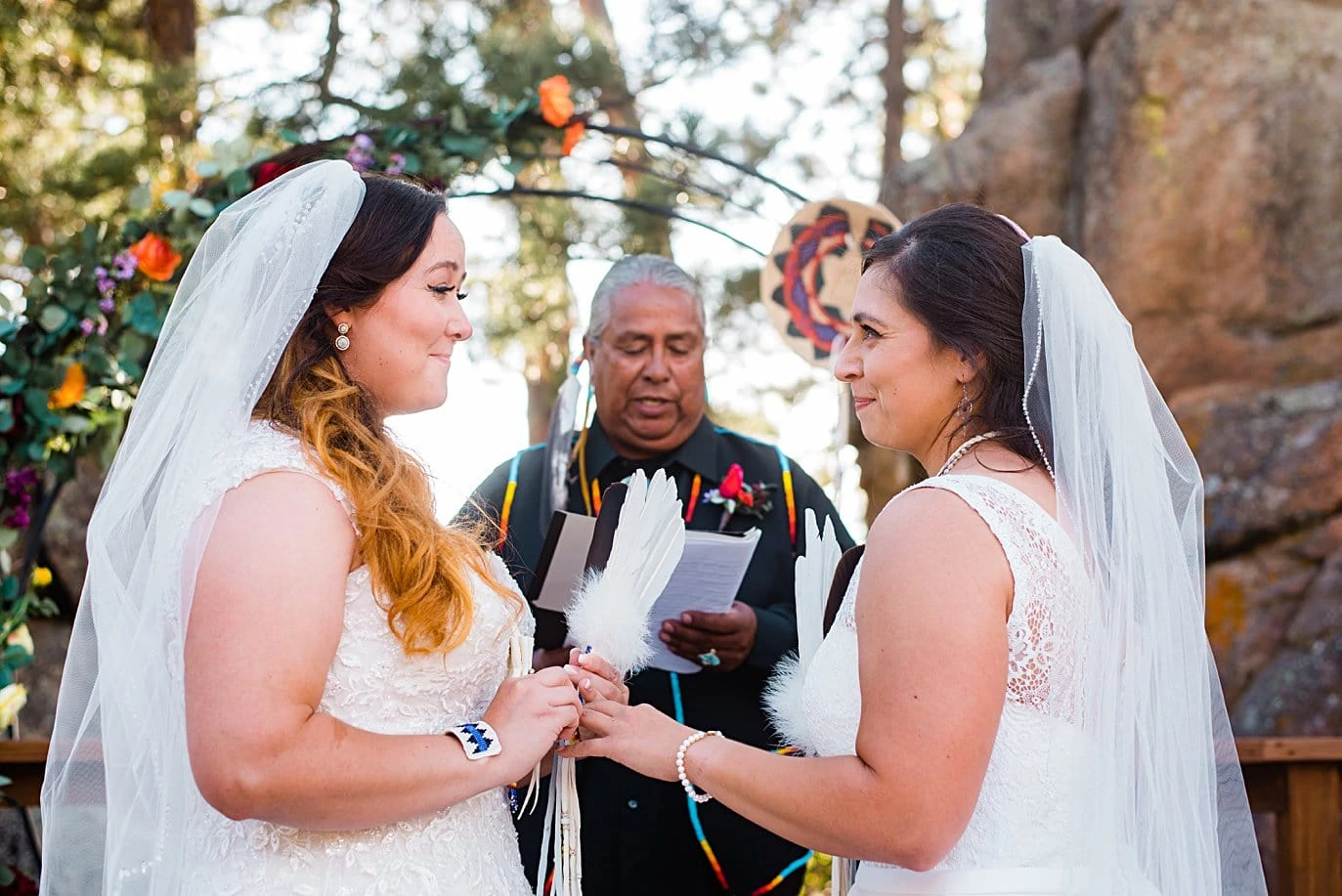 brides exchange rings during queer wedding ceremony at fall Deer Creek Valley Ranch wedding by Boulder wedding photographer Jennie Crate