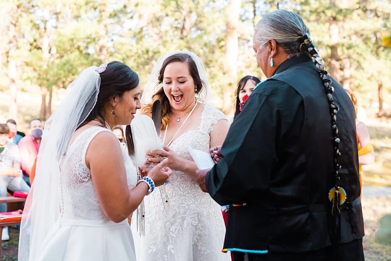 brides exchange rings excitedly at fall Deer Creek Valley Ranch wedding by Boulder wedding photographer Jennie Crate