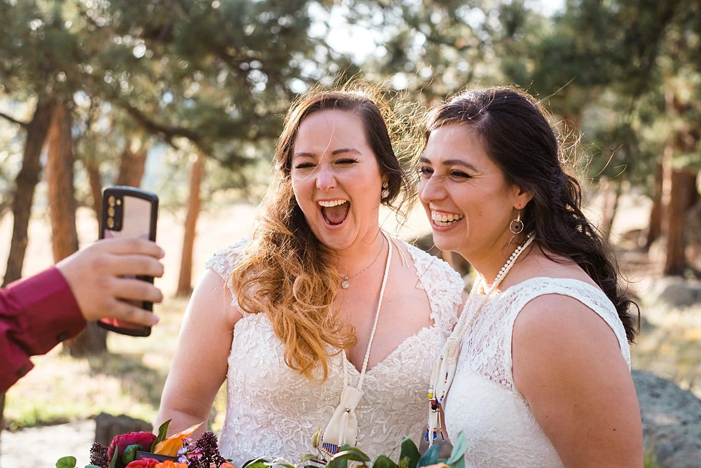 two brides celebrate with friends over zoom at LGBT wedding by Colorado LGBT wedding photographer Jennie Crate