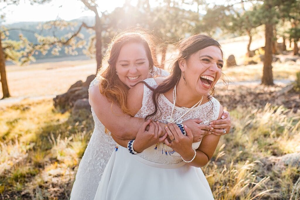 two brides in dresses intimate wedding ceremony at LGBT wedding by Colorado LGBT wedding photographer Jennie Crate